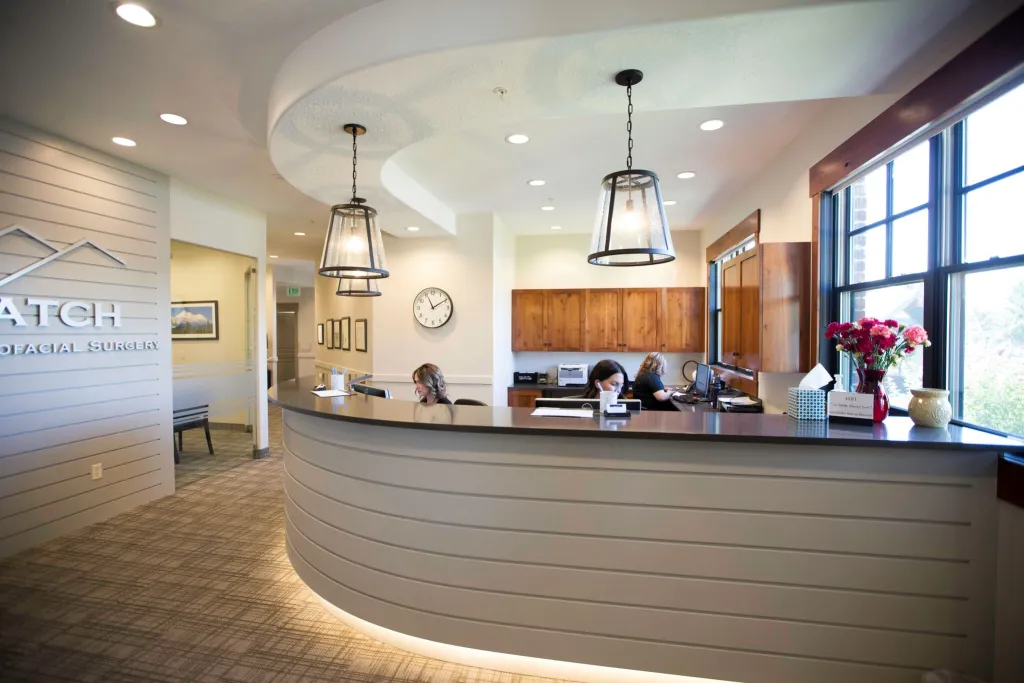 Three staff members working at the front desk