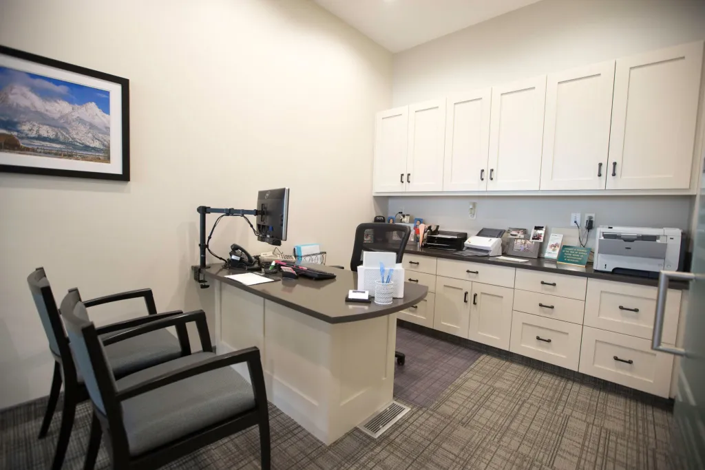 Treatment planning area with desk and two chairs for patients